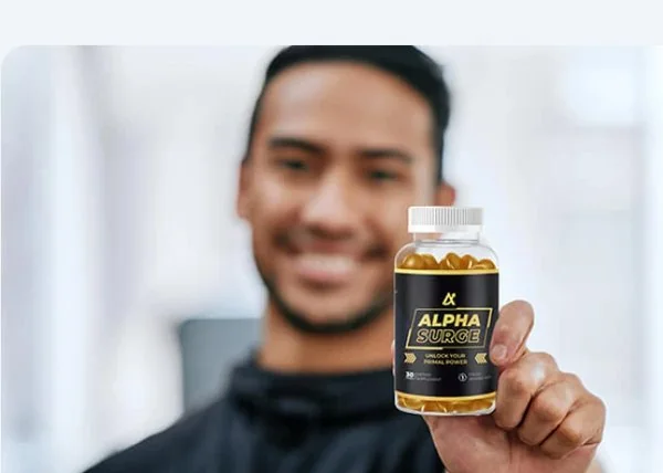 Man holding a bottle of Alpha Surge gummies