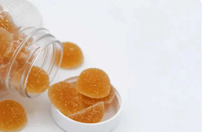 Fruity gummies spilling from a jar